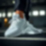 Adidas white running shoes showcasing sleek design