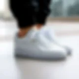 Stylish white Puma sneakers on a minimalistic background