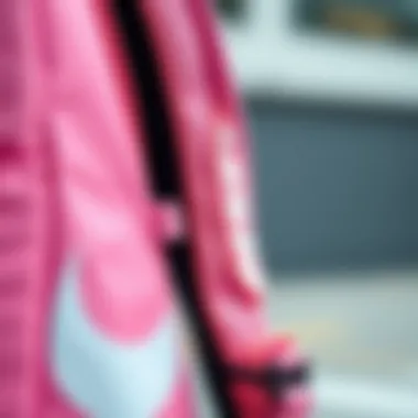 Close-up detail of the pink Nike backpack's design features
