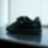 Stylish black leather Puma shoes on a sleek surface