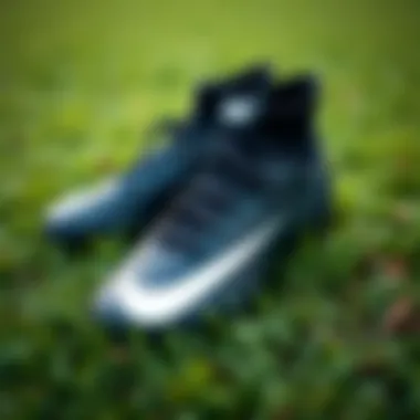Stylish black Nike football boots on a grassy field